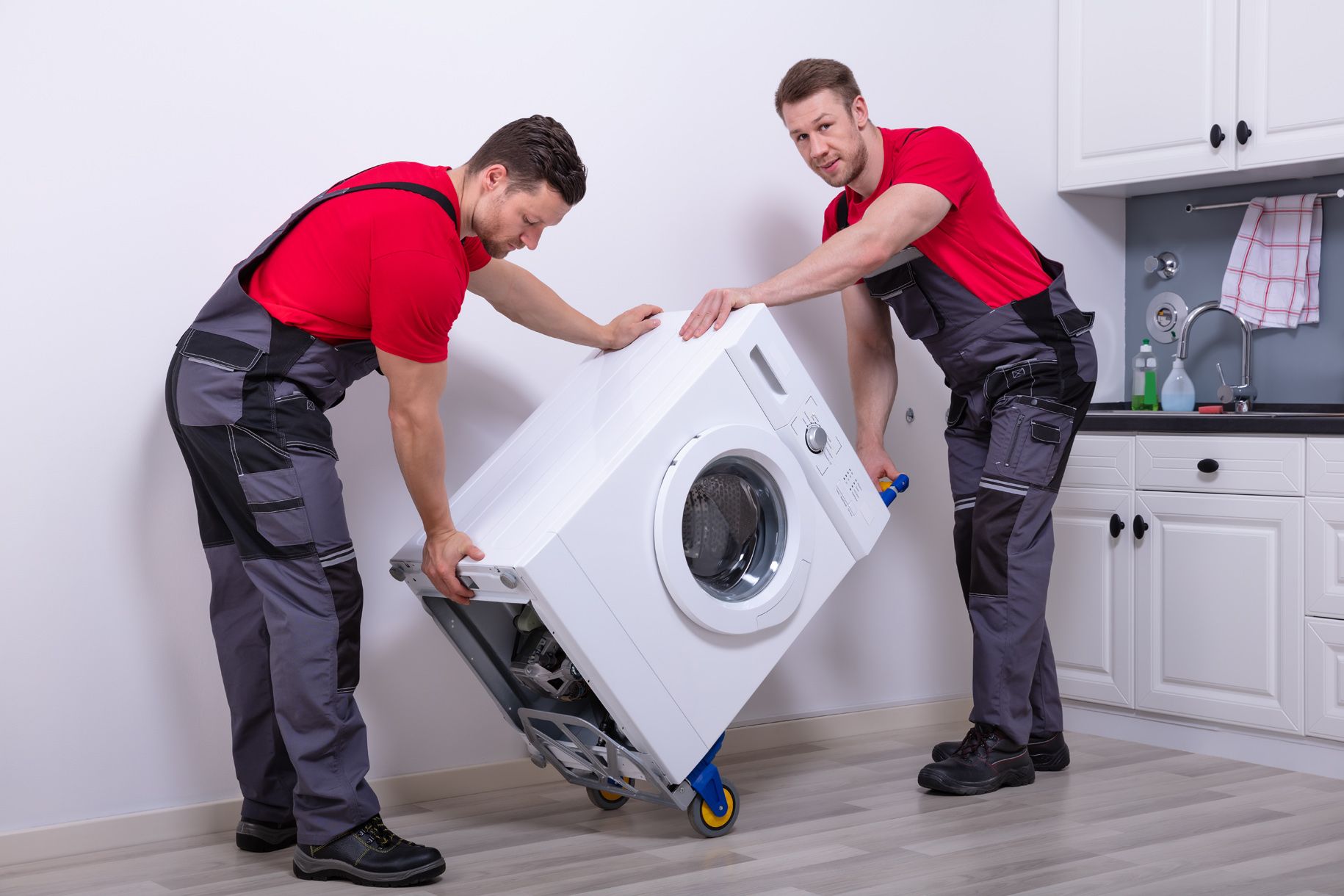 Rutz Mitarbeiter transportieren eine Waschmaschine